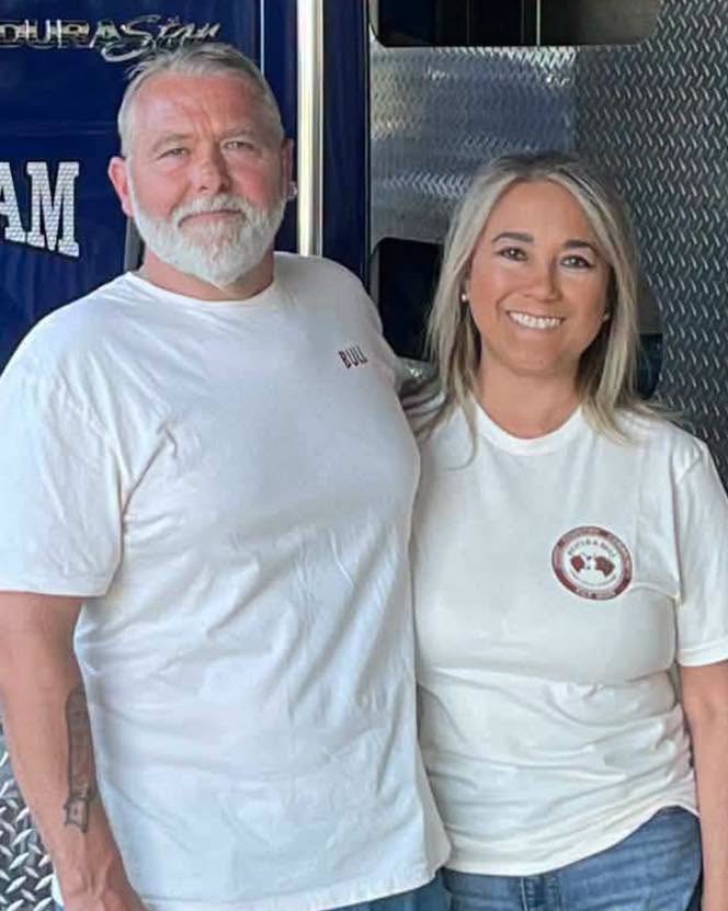 Ryan and Laura standing together in matching shirts